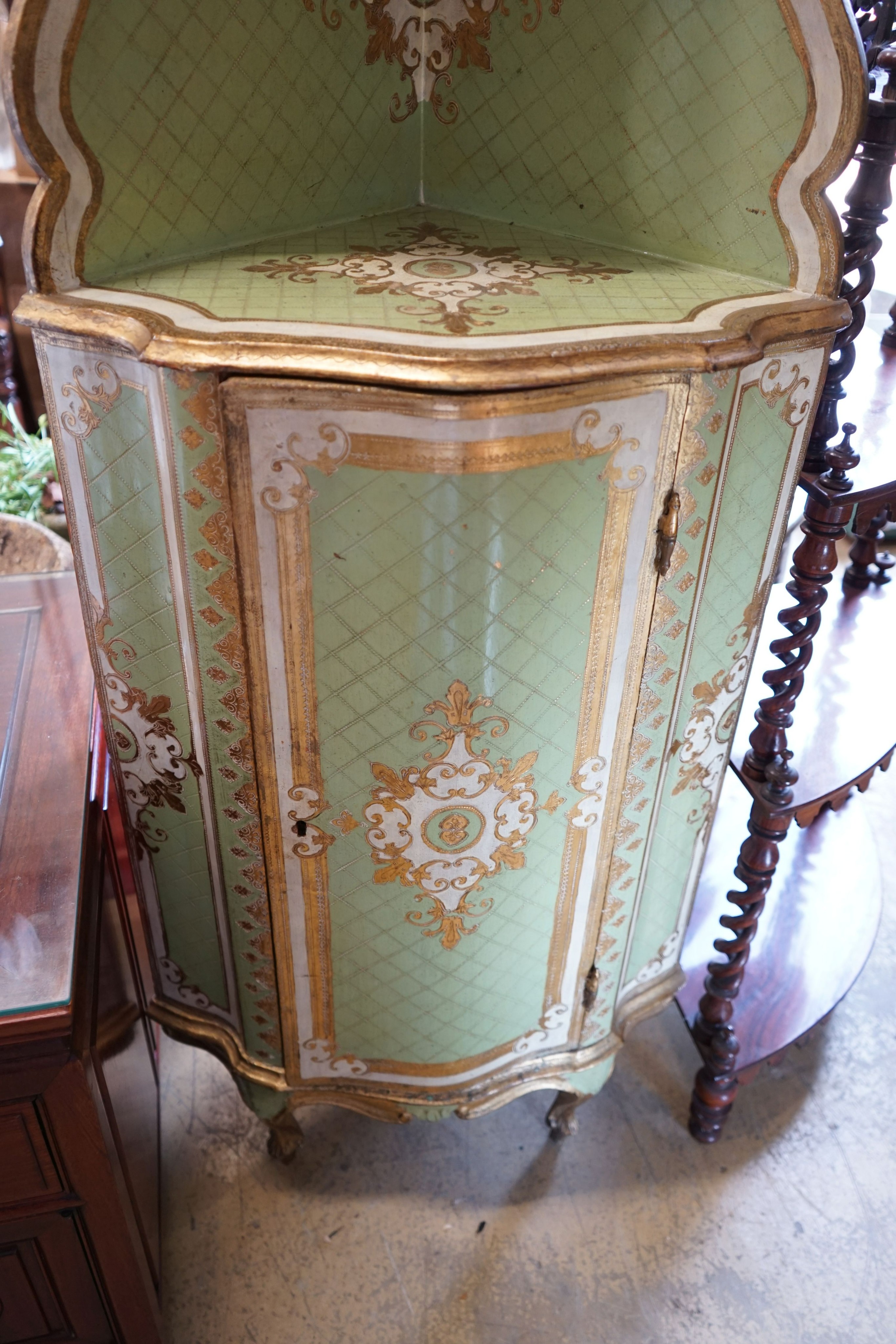 An Italian painted parcel gilt standing corner cabinet, width 57cm, depth 39cm, height 189cm